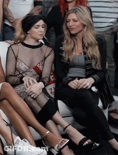 Women Sitting On Couch With Fishnet Top GIF