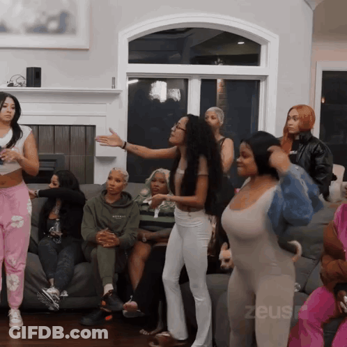 Women Sitting On Couch With Zeus GIF