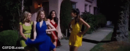 Women Standing On Sidewalk In Front Of House GIF