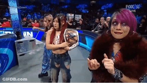Women Standing On Stage Holding Championship Belt GIF