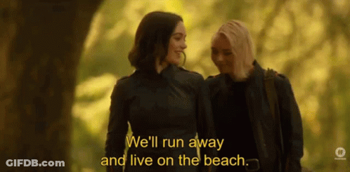 Women Walking In Woods Discussing Living On Beach GIF