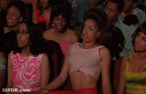 Women Watching Movie In Theater, One In Crop Top GIF