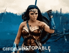 Wonder Woman Standing In Field With Shield And Sword GIF