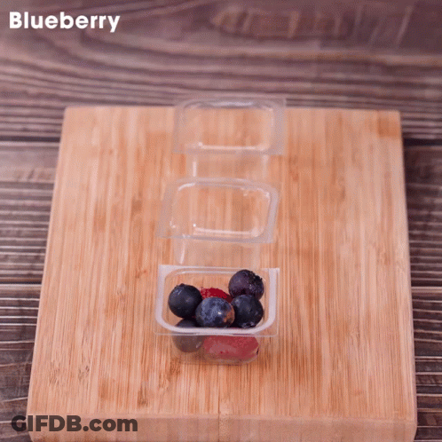Wooden Cutting Board With Blueberries And Raspberries GIF