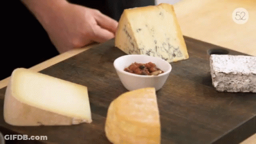 Wooden Cutting Board With Cheeses And Sauce Number 52 GIF