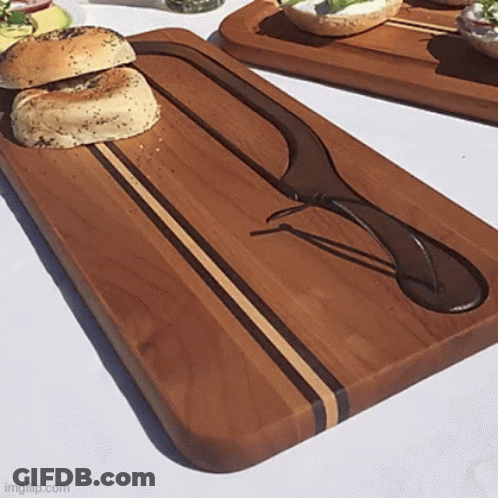 Wooden Cutting Board With Knife And Bagel GIF