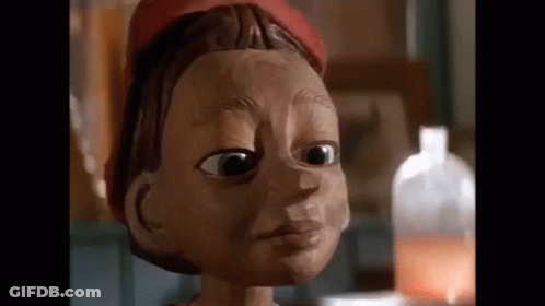 Wooden Puppet Face With Red Hat GIF