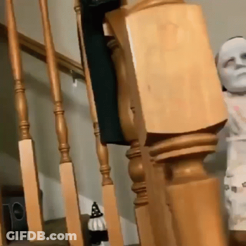 Wooden Railing Next To Statue Of Man GIF