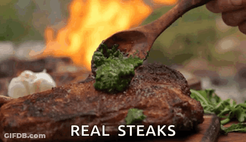 Wooden Spoon Spreading Pesto On Steak GIF