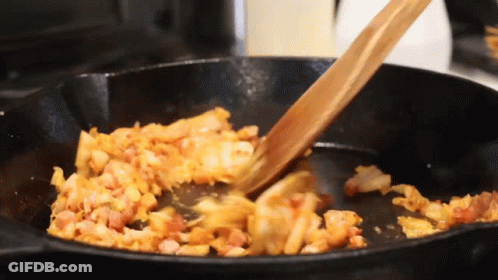 Wooden Spoon Stirring Food In Frying Pan GIF
