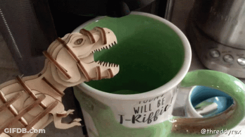 Wooden T-Rex Sticking Head Out Of Coffee Mug Saying T-Rifff GIF