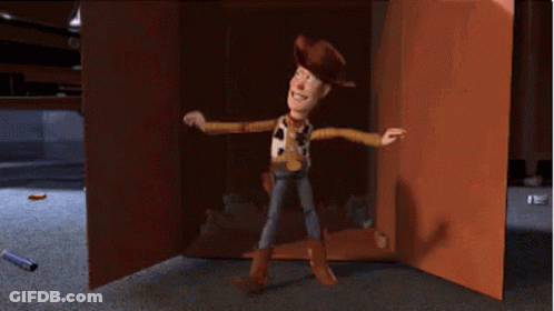 Woody From Toy Story Is Standing In Front Of A Cardboard Box GIF