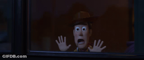 Woody From Toy Story Looking Out Of A Window With His Hands Up GIF