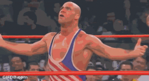 Wrestler Arms Outstretched In Ring With Crowd GIF