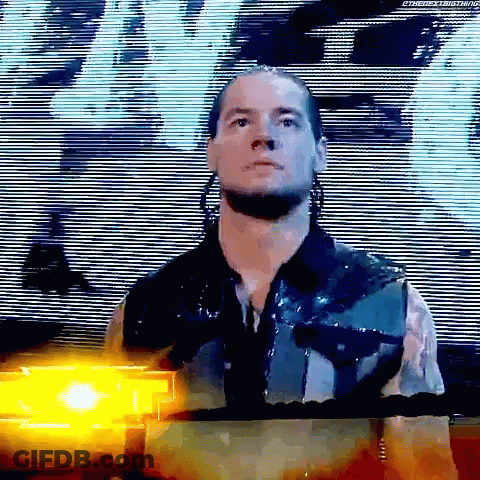 Wrestler Before Large Screen With Yellow Light Behind GIF