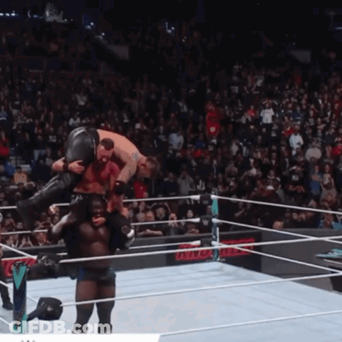 Wrestler Carrying Another Wrestler In Ring GIF
