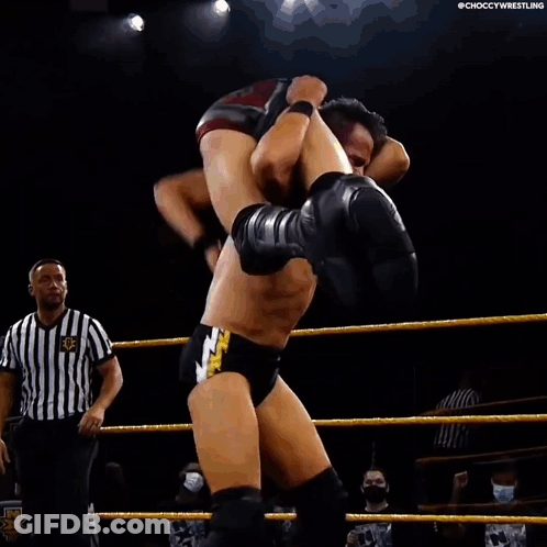 Wrestler Carrying Another Wrestler On Back In Ring GIF