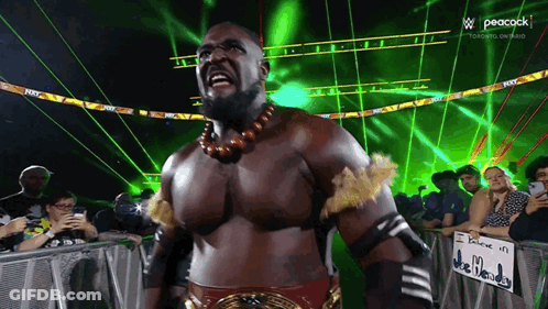 Wrestler Facing Crowd With Peacock Logo GIF