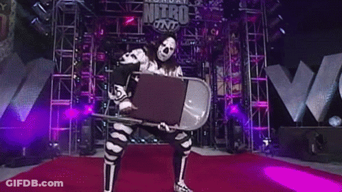 Wrestler Holding Chair On Red Carpet GIF