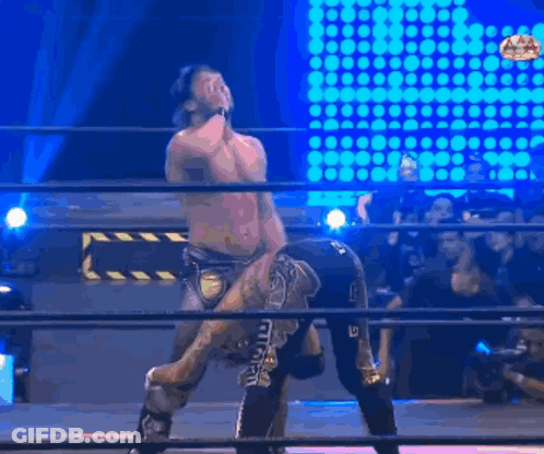 Wrestler Holding Opponent On Shoulders In Ring GIF