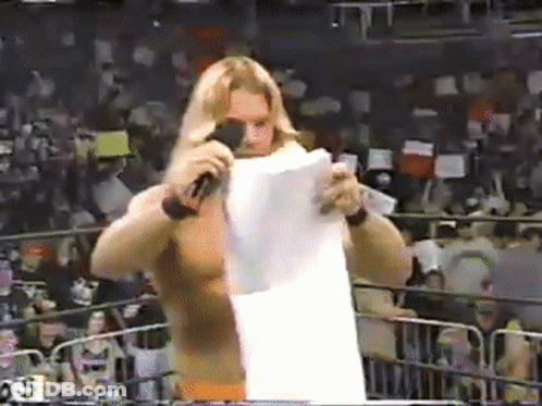 Wrestler Holding Paper In Front Of Microphone GIF