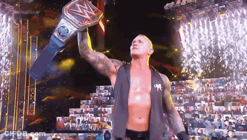 Wrestler Holding World Heavyweight Championship Belt Over Head GIF