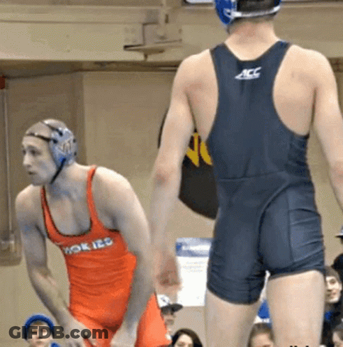 Wrestler In ACC Uniform Next To Wrestler In Orange Tank Top GIF