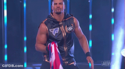 Wrestler In Black And Gold Holding Flag GIF