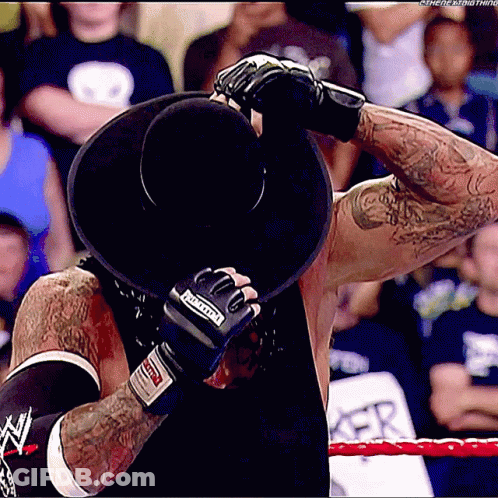 Wrestler In Black Hat With Undertaker Boxing Gloves GIF