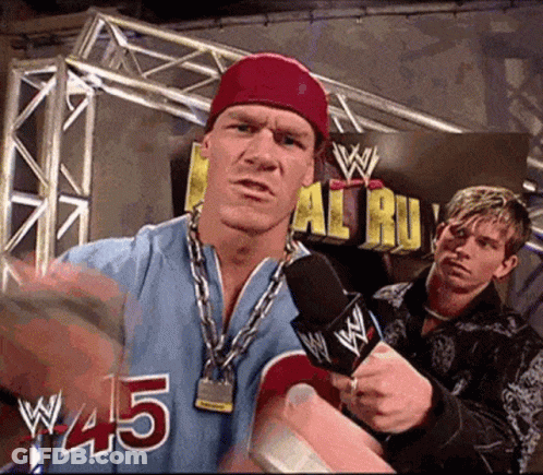 Wrestler In Blue Jersey #45 Speaking Into Microphone GIF