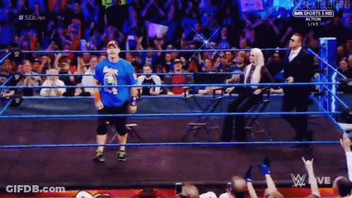 Wrestler In Blue Shirt Walking Out Of Ring GIF