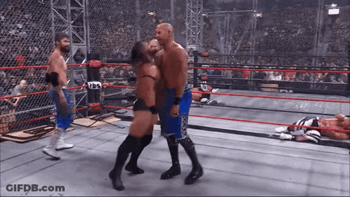 Wrestler In Blue Shorts Kissing Another Wrestler In Boxing Ring GIF