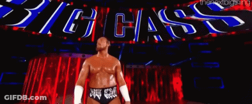 Wrestler In Front Of Big Cass Sign GIF
