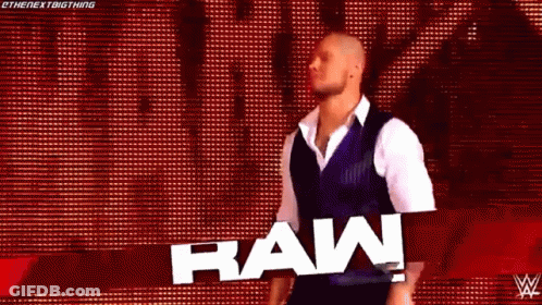 Wrestler In Front Of Raw Sign GIF