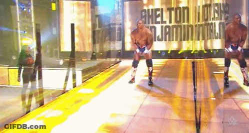 Wrestler In Front Of Wall Saying Shelton GIF