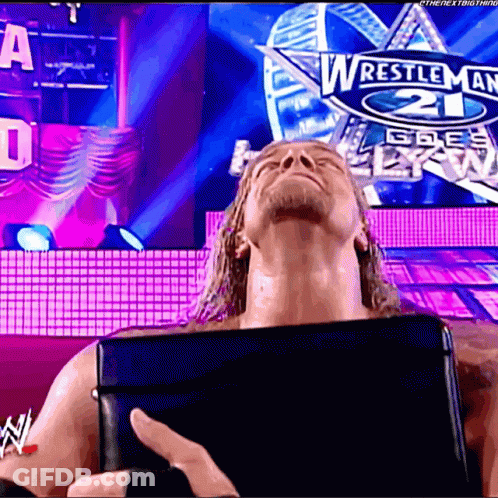 Wrestler In Front Of Wrestlemania 21 Sign GIF