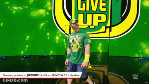 Wrestler In Green Shirt Saying Give Up GIF