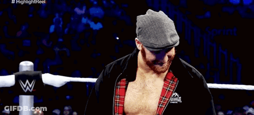 Wrestler In Hat And Plaid Shirt Covering Mouth GIF