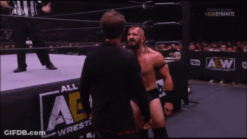 Wrestler In Mask Talking To Another Wrestler By AE Wall GIF