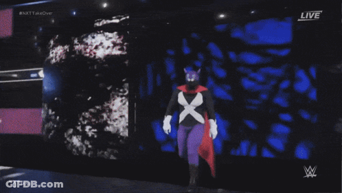 Wrestler In Purple Cape Standing In Ring GIF
