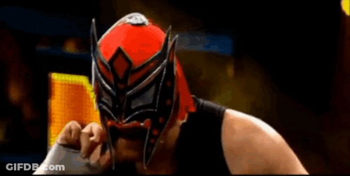 Wrestler In Red And Black Mask Holding Sword GIF