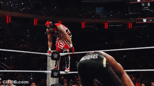 Wrestler In Red And White Outfit Jumping Over Ropes GIF