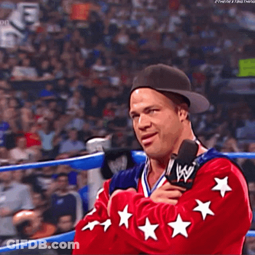 Wrestler In Red Jacket With Stars Talking Into Microphone GIF