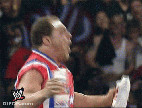 Wrestler In Red White Blue Jersey Holding Paper GIF