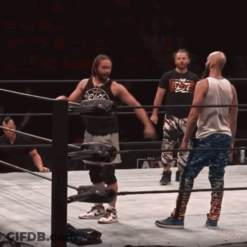 Wrestler In Ring Wearing The Elite Shirt GIF