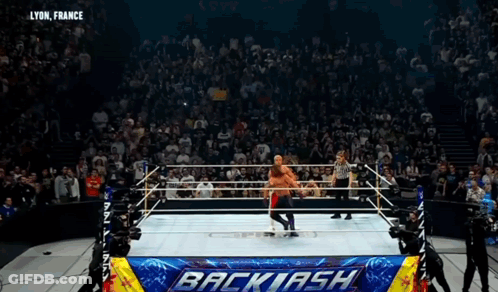 Wrestler In Ring With Backlash Banner GIF