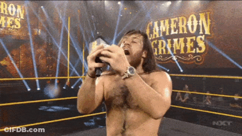 Wrestler In Ring With Cameron Grimes On Wall GIF