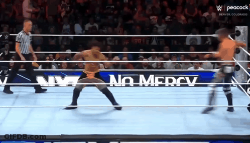 Wrestler In Ring With No Mercy Sign GIF