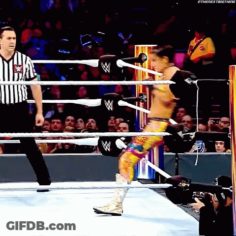 Wrestler In Ring With Referee Behind Him GIF