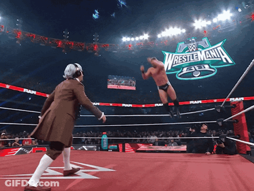Wrestler In Ring With Wrestlemania Sign GIF